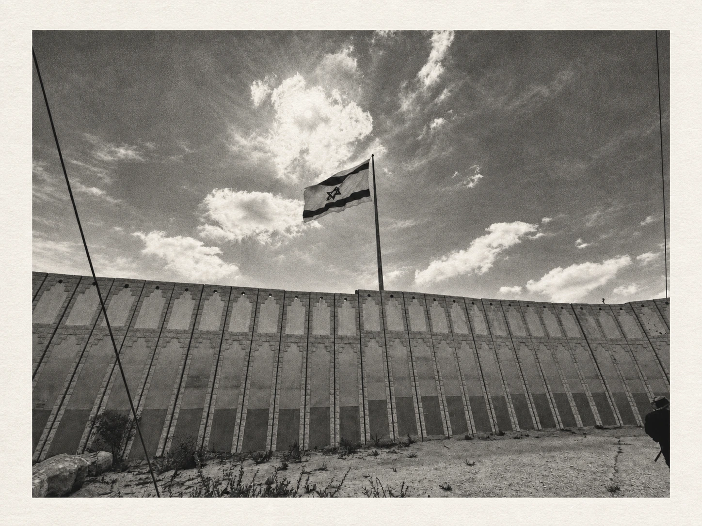 Ground Zero IV, photogravure · Shlomo Kashani · October 7 book An Israeli flag above the border wall. Ground Zero IV, photogravure by Shlomo Kashani from Traces of October, the companion art book to his October 7 book.